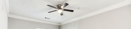 Bedroom with wooden floor and ceiling fan and light at Preserve  at Mill Creek, Buford, Georgia