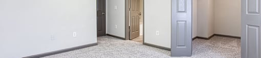 a bedroom with a closet and an open door