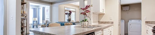 a kitchen with white cabinets and a large island