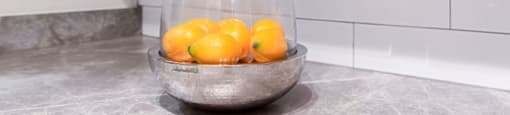 a bowl of lemons in a kitchen