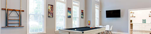 a game room with a pool table and a flat screen tv