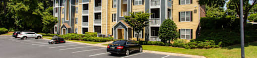 a large apartment building with a parking lot in front of it