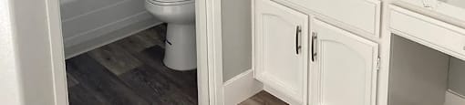 A white bathroom with a toilet and sink.