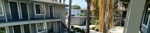 the view of the courtyard from the balcony of a condo building