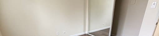 A room with a wood floor and a closet with a sliding door. 419 Baden Avenue 419 Baden Avenue  South San Francisco, CA 94080