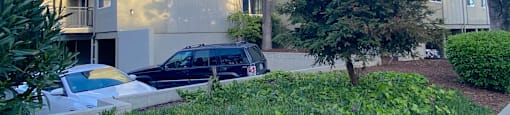 an apartment building with a car parked in front of it