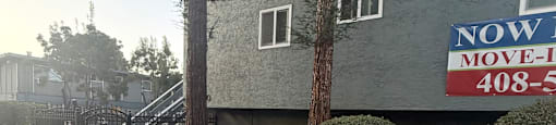 A sign on a building that says "NOW MOVE-IN" and the number "408-5".