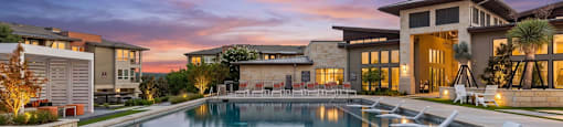 A large swimming pool in front of a modern building.