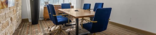 A conference room with a large table and chairs.