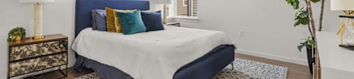 A bedroom with a blue headboard and a white bedspread.