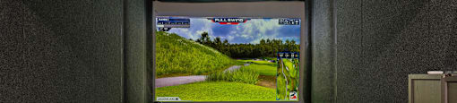 A golf simulator room with a screen showing a golf course.