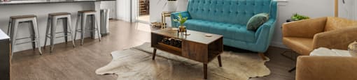 A living room with a blue couch and a wooden coffee table.