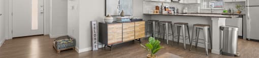 A modern kitchen with a wooden table in the middle of the room.