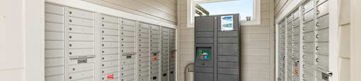 A row of grey electrical boxes are lined up on a wall.