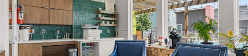 A kitchen with blue chairs and a wooden table.