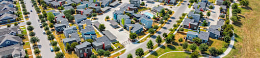 A bird's eye view of a residential area with houses and roads.