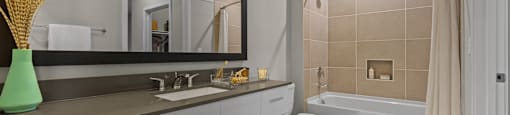 A bathroom with a white toilet, a sink, and a bathtub.