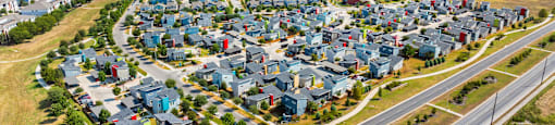 A bird's eye view of a residential area with houses and roads.