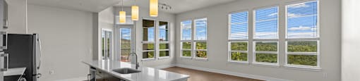 A spacious kitchen with wooden floors and a large island.
