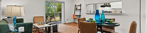 A living room with a dining table and chairs.