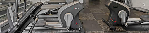A gym with treadmills and elliptical machines.