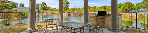A wooden patio with a table and chairs.