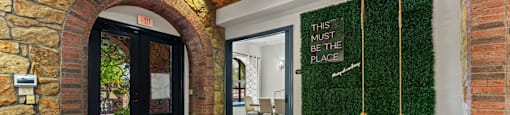 A room with a green wall and a wooden floor.