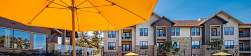 A sunny day at the pool with yellow umbrellas and sun loungers.