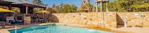 A pool with a windmill and water tower in the background.