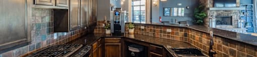 A kitchen with wooden cabinets and black appliances.