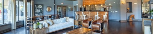 A living room with a white sofa and a wooden coffee table.