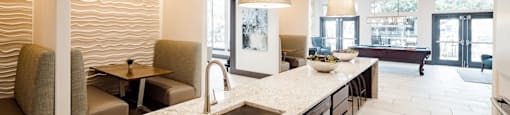 A modern kitchen with a marble countertop and a large island.