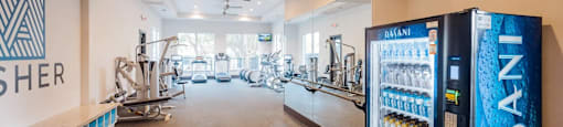 A room with a vending machine and exercise equipment.