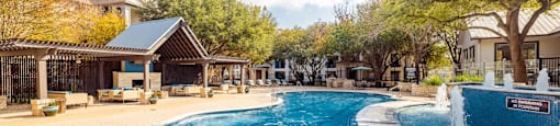 A large outdoor swimming pool with a waterfall feature.