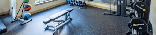 A well-equipped home gym with a variety of exercise equipment.