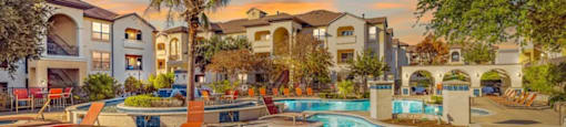 A large swimming pool surrounded by a resort-style setting.