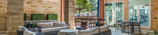 the lobby of a hotel with couches and chairs and a table