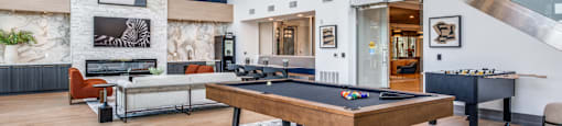 an open living room with a pool table and a games room