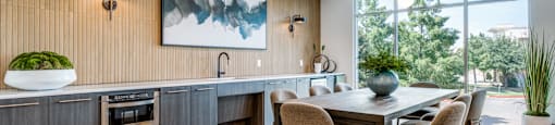 a kitchen and dining room with a table and chairs
