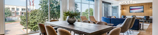a dining room with a table and chairs and a large window