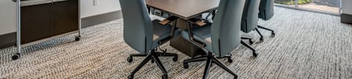 a conference room with a long table and chairs and a window