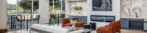 a living room with a couch and chairs and a fireplace