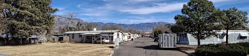A parking lot with a mountain in the background.