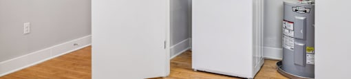 a small laundry room with a washer and dryer in it and a door