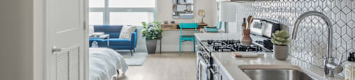 A kitchen with a sink and a window.