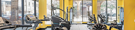 A gym with treadmills and exercise bikes.
