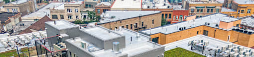 A rooftop patio with a table and chairs.