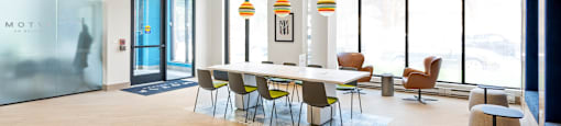 A conference room with a long table and chairs.
