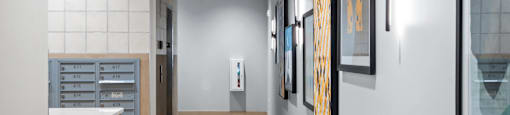 A hallway with a series of framed pictures on the wall.