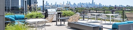 A rooftop patio with a view of the city skyline.